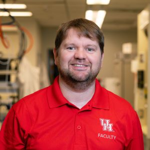 Man in red shirt standing in laboratory